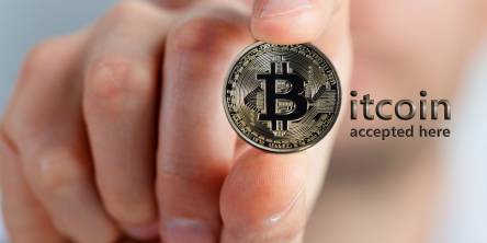 hand holding a bitcoin physical coin