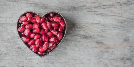 A heart made out of pomegranate seeds. 